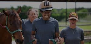 Therapeutic Riding - Therapist walking with client and horse