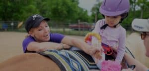 Therapeutic Riding - Child working with therapist