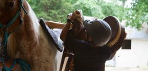 Equine Assisted Therapy - Child saddling horse